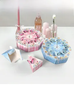 Detail of creative butterfly cake shaped gift boxes in pink and blue for party favors