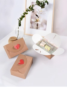 Close-up of heart-shaped gift box with red cutout detail and colorful shredded paper