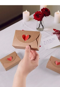 Close-up of brown kraft gift box with red 3D heart-shaped buckle and rose decoration