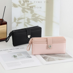 Close-up of long PU leather wallets with heart buckle and woven wristlet straps