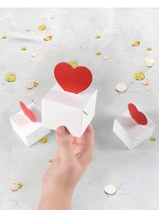 Close-up of a white cube candy box featuring a 3D red heart topper for Valentine gifts