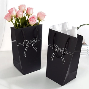 Minimalist black trapezoid paper gift bag with white bow line art for flowers or toys