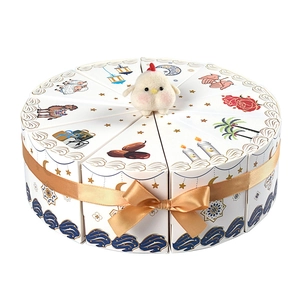 Triangle cake-shaped gift boxes with white plush bird and golden ribbon bow decor