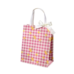 Pink plaid paper gift bag with yellow daisy patterns and a white decorative bow