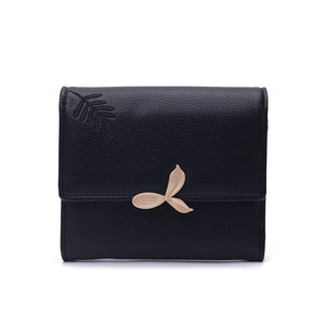 Close-up of black lychee texture PU leather wallet with gold leaf metal clasp detail