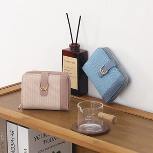 Detail of short PU leather wallets with horseshoe buckles on a wooden shelf scene