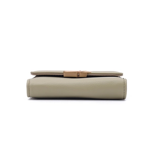 Detailed side view of sage green faux leather wallet with premium lychee grain texture