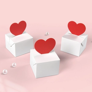 White folding gift boxes with 3D red heart toppers for Valentine's Day packaging