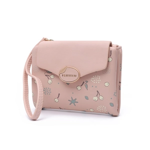 Detailed view of pink floral wallet featuring cherry prints and a golden oval metal clasp