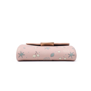 Detail of pink PU leather wallet with cherry floral print and secure snap closure