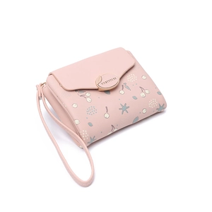 Detail of pink PU leather wallet featuring cherry and polka dot prints with metal buckle