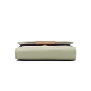 Detail view of the pale green lychee pattern leather texture and gold hardware clasp