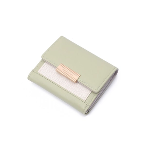 Close-up of light green trifold wallet with hardware buckle and leather texture