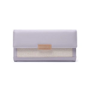 Detail of purple leather and beige woven panel long wallet with gold metal clasp