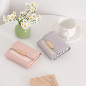 Close-up of pink and purple tri-fold faux leather wallets with elegant woven texture detail