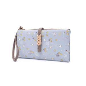 Detailed side view of a light blue floral long wallet with golden wheat buckle and wristlet