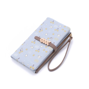 Detail view of floral long wallet with cherry print, zip compartments and wrist strap