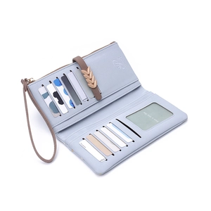 Detail view of light blue long wallet showing multiple card slots and metal leaf clasp