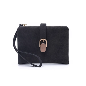 Detailed view of a black suede wristlet wallet featuring a golden horseshoe buckle
