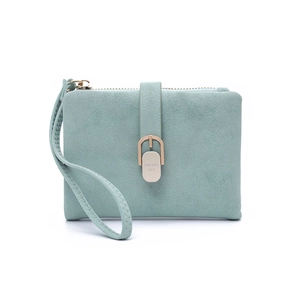Detail of mint green suede wallet with gold metal clasp and a convenient wrist strap