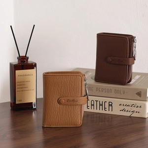 Detail view of retro litchi grain leather wallets with metal zippers and snap closure