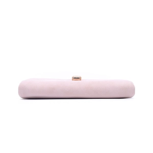 Detail of light pink suede clutch featuring a sophisticated gold rectangular metal buckle