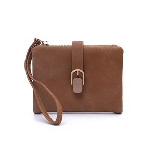Close-up of brown suede women's short wallet with decorative U-shaped metal buckle and wrist strap