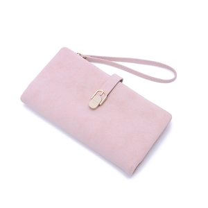 Detail of dusty pink long wallet with matte texture, gold buckle, and wristlet strap