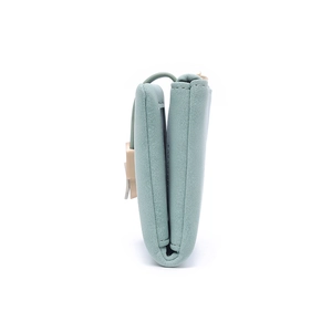 Detail view of mint green tri-fold PU leather wallet with neat edge stitching and metal clasp