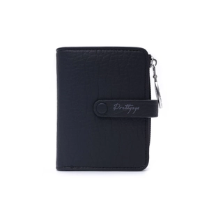 Close-up of black lychee grain faux leather texture and silver zipper detail on wallet