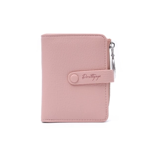 Close-up of pink litchi grain leather wallet with snap button and zipper pocket