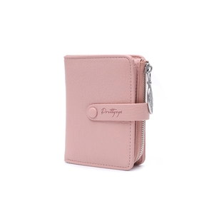 Detail of pink lychee leather wallet featuring a leaf zipper pull and snap closure