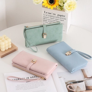 Detailed view of long PU leather wallets in mint, blue, and pink with wrist straps