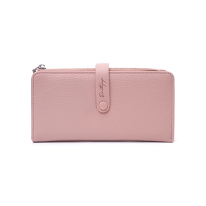 Detail view of pink leather long wallet showing fine texture and snap closure with lettering