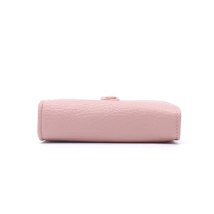 Detailed bottom view of pink litchi grain leather wallet showing neat stitching work