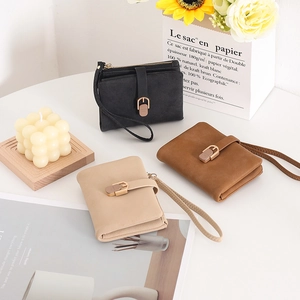 Detailed view of multiple PU leather wallets in black, brown and apricot colors