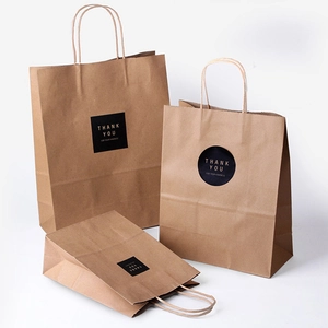 Brown kraft paper gift bags with twisted handles and gold Thank You sealing stickers