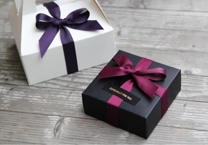 Elegant gift boxes with grooved wine red ribbons and Especially For You gold labels