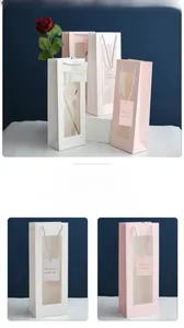 Detail view of wine gift bag with clear window and decorative tag 13x8.5x34 cm