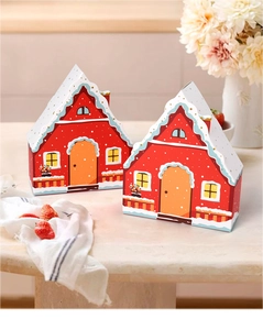 Detailed view of red house-shaped gift boxes with snowy roof and fence details