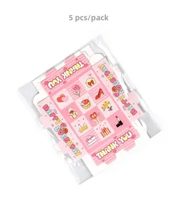 Close-up of pink checkered gift boxes with Thank You and Happy Everyday greetings
