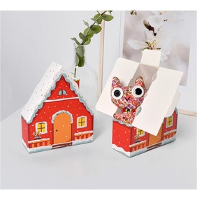 Charming red house gift box featuring a white snowy roof and cute cat fabric toy inside