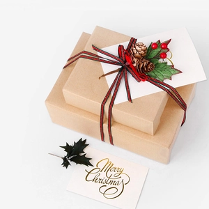 Merry Christmas kraft paper gift boxes decorated with pine cones and striped ribbons