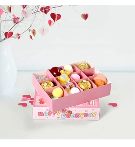Pink 12-grid gift box detail with colorful plush balls, chocolates and small toys