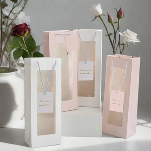 Detail of pink and white gift bags with transparent window and woven handle