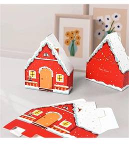 Detail of red house-shaped gift box with snowy roof and flat unassembled base parts