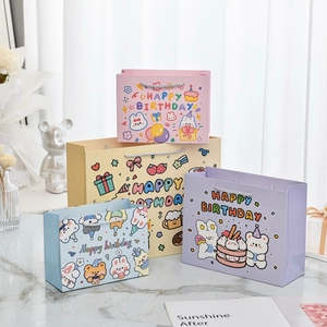 Cartoon rabbit birthday gift bags in pink yellow and blue colors for children parties