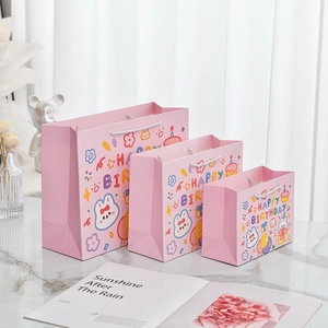 Detailed set of pink cartoon rabbit gift bags in three sizes for birthday celebrations