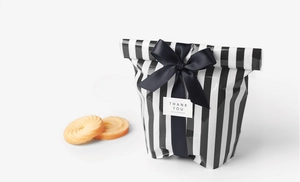 Detail of black and white striped cookie bag with satin bow and Thank You tag
