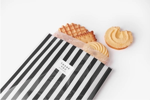 Close-up of black and white striped cookie packaging bags with Thank You stickers